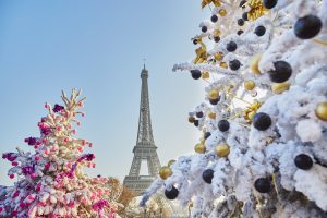 Christmas tree covered with snow near the Eiffel tower in Paris